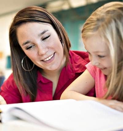 woman giving an enrollment evaluation to a child for memorial christian academy private school