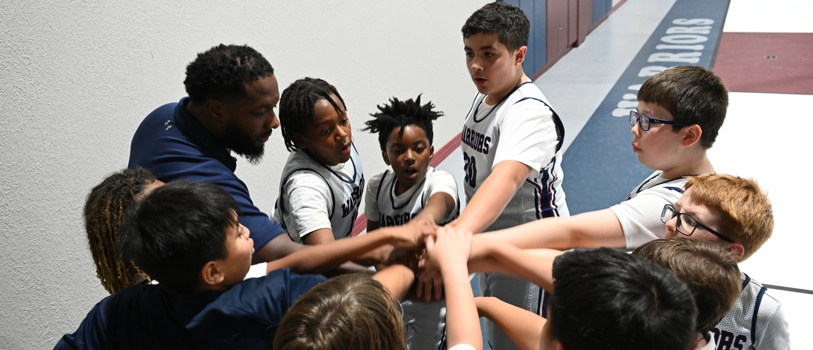 Children and coach in a huddle